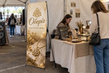 Х-банер Junior 60×160 см для ювелірного бренду Оберіг на ярмарку біля вітринного столу.
